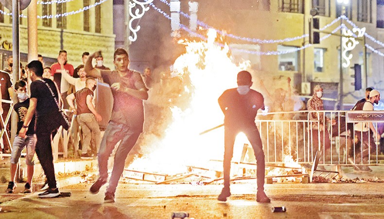 Palestinian protesters hurl stones at Israeli security forces amid clashes in Jerusalem’s Old City on Saturday night. — AFP photo