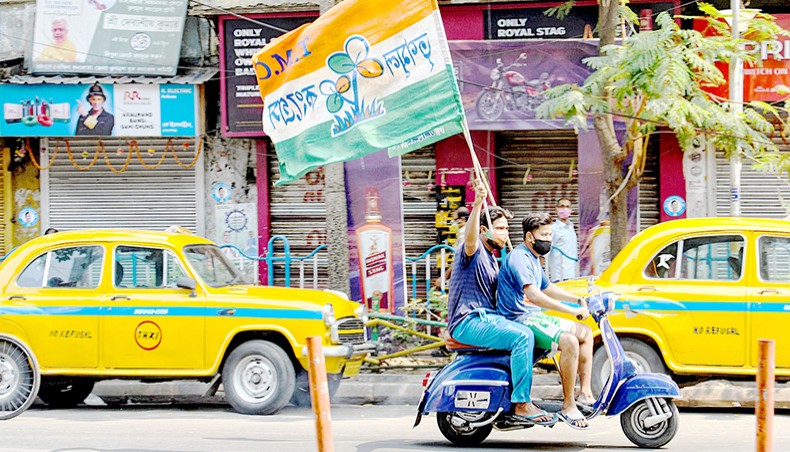 Supporters of the Trinamool Congress party celebrate the party’s lead in the West Bengal state legislative assembly elections during counting in Kolkata on May 2. — Agence France-Presse