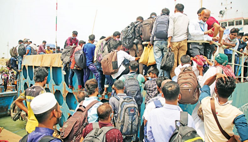 People on their way to native areas desperately try to get on a ferry even after the closure of its door at Shimulia ferry terminal in Munshiganj on Tuesday. — Sony Ramany