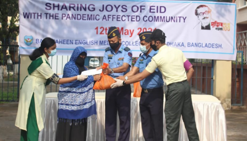 BAF Shaheen English Medium College authorities distribute Eid gifts among the needy people in the college-adjacent areas in Dhaka on Wednesday.