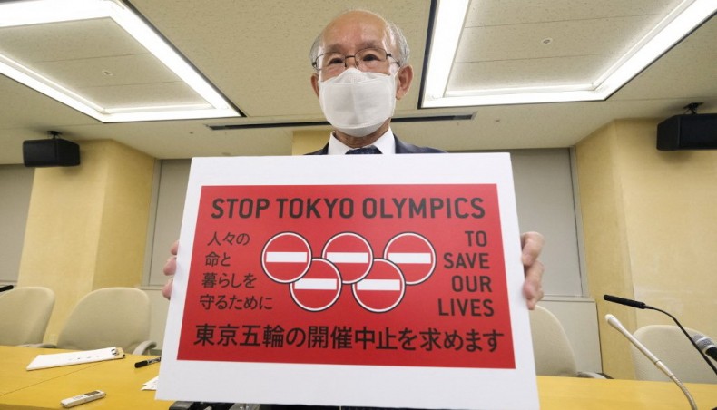 Kenji Utsunomiya, a Japanese lawyer and former Tokyo gubernatorial candidate, poses with a campaign slogan Stop Tokyo Olympics, after handing the petitions to the Tokyo Metropolitan Government in Tokyo on Friday.-- AFP photo