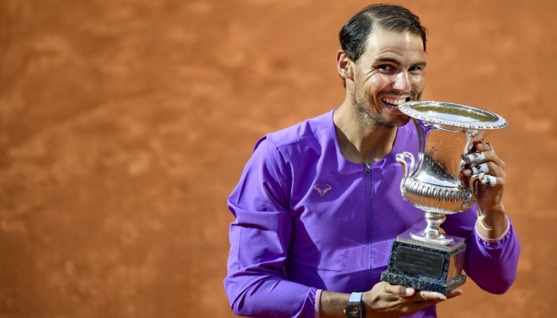 Spain's Rafael Nadal bites the winner's trophy after defeating Serbia's Novak Djokovic in the final of the Italian Tennis Open at Foro Italico in Rome on Sunday. — AFP photo