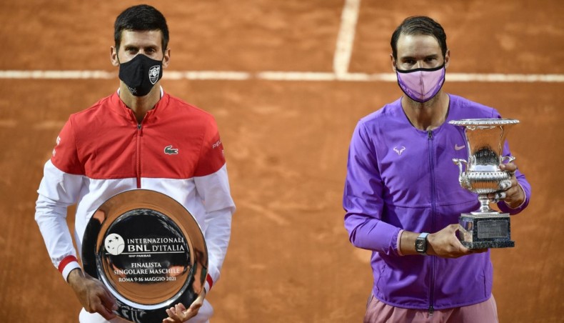 Serbia's Novak Djokovic (L) and Spain's Rafael Nadal pose with their respective trophies at the end of their Italian Tennis Open final at Foro Italico in Rome on Sunday. — AFP photo