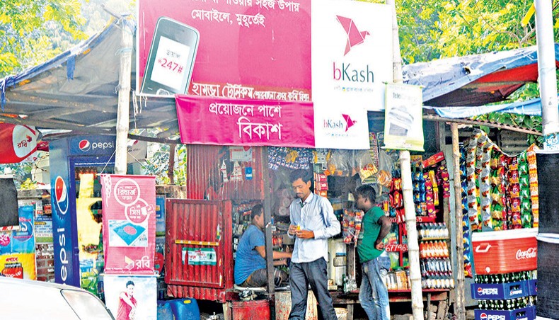 A file photo shows a man walking out of a recharge point of a mobile financial service in the capital. The interoperability of mobile financial services is yet to be implemented in almost two years of taking an initiative in this regard. — New Age photo