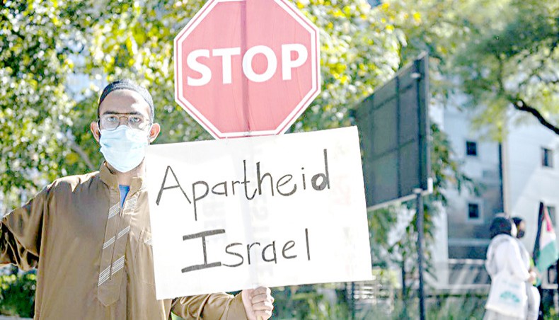 A group of South Africans hold banners during a demonstration to protest Israeli attacks on Palestinians at Masjid al-Aqsa in Jerusalem and Gaza Strip, on May 11, 2021, in Sandton district of Johannesburg, South Africa. — Common Dreams/Getty Images/Ihsaan Haffejee