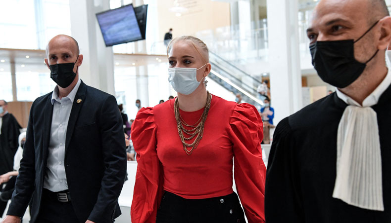 Eighteen-year-old Mila walks back to the courtroom with her lawyer Richard Malka after a break during the opening hearing of the so-called ‘Mila case’ trial where thirteen people face charges of online harassment and in some cases death threats against the then teenager who posted social media tirades against Islam, which saw her placed under police protection and forced to change schools, on June 3, 2021 in Paris. — AFP photo