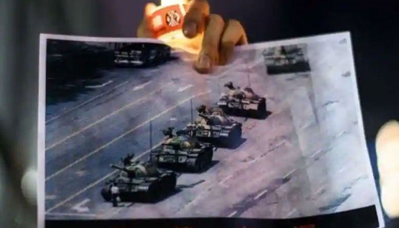 A man holds a poster of the famous 'Tank Man' standing in front of Chinese military tanks at Tiananmen Square in Beijing on June 5, 1989, during a candlelit remembrance in Victoria Park in Hong Kong on June 4, 2020. --AFP photo