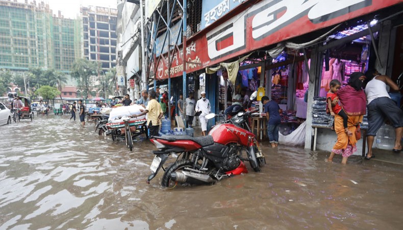 Fulbaria road in front of Bangabazar in Dhaka goes under water following a downpour on Wednesday. — Sourav Lasker