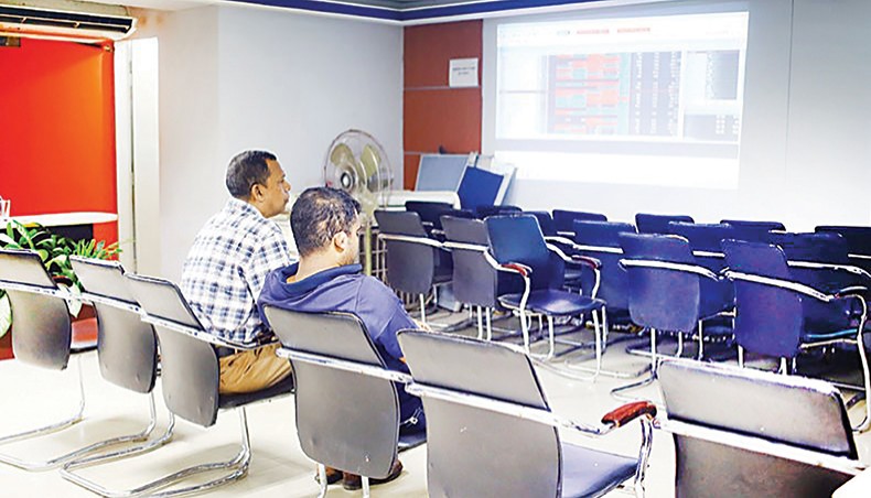 A file photo shows investors monitoring share price movement on a computer screen at a brokerage house in the capital Dhaka. The Bangladesh Bank and the Bangladesh Securities and Exchange Commission have decided to allow stock market investors to trade government’s treasury bonds through their beneficiary owners’ accounts opened with brokerage houses. — New Age photo