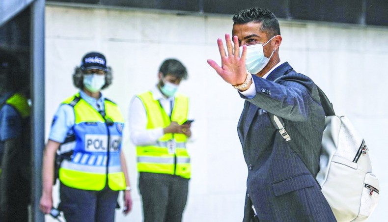 Portuguese superstar Cristiano Ronaldo waves as he arrives at Lisbon airport prior to the team’s departure for Budapest on Thursday. — AFP photo