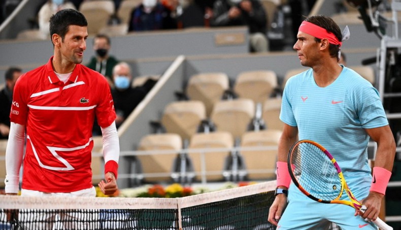 This file photo taken on October 11, 2020 shows Spain's Rafael Nadal (R) and Serbia's Novak Djokovic talking prior to their men's final at the Philippe Chatrier court at The Roland Garros in Paris. — AFP photo