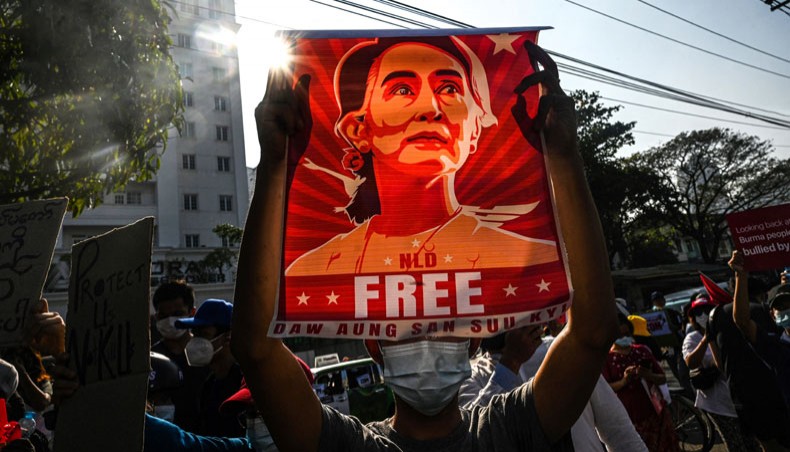 In this file photo taken on February 15, 2021, a protester holds up a poster featuring Aung San Suu Kyi during a demonstration against the military coup in front of the Central Bank of Myanmar in Yangon. Myanmar’s deposed leader Aung San Suu Kyi has been hit with fresh corruption charges, state-run media reported on June 10, 2021. – AFP photo