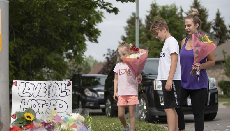 Families pay their respects on June 8, 2021, at a makeshift memorial near the site where a man driving a pickup truck struck and killed four members of a Muslim family in London, Ontario, Canada. Canadian prime minister Justin Trudeau had labeled it as a ‘terrorist attack.’— AFP Photo