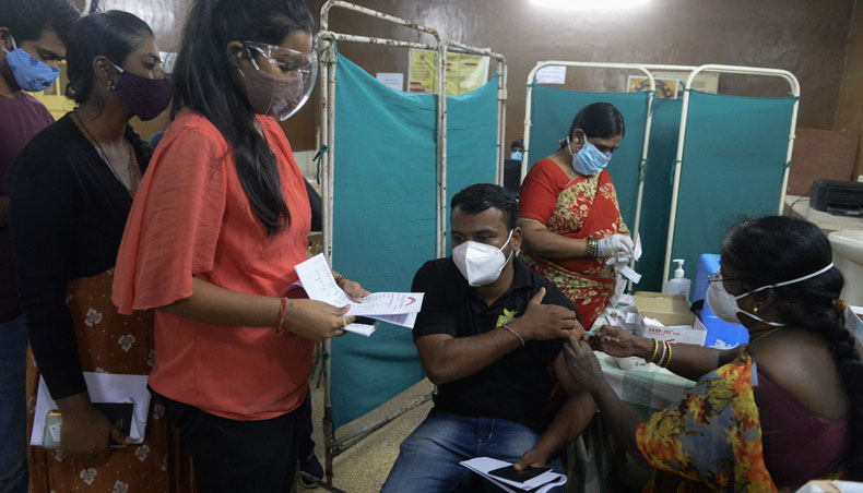 A health worker inoculates a student with a dose of the Covishield Covid-19 vaccine during a vaccination drive for students travelling abroad at the International Health Vaccination Centre in Hyderabad on June 11, 2021. — AFP photo
