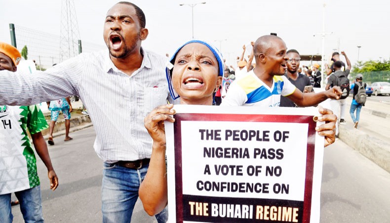 A woman carries a banner during a demonstration at Ojota in Lagos on Saturday, as Nigerian activists called for nationwide protests over what they criticise as bad governance and insecurity, as well as the recent ban of US social media platform Twitter by the government of president Muhammadu Buhari. Hundreds of protesters gathered on Saturday in Lagos, a sprawling megapolis of over 20 million people, and police fired tear gas to disperse the crowd. —AFP photo