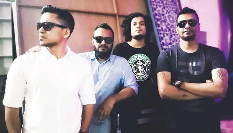 Khademul Jahan, second from left, along with members of Black poses for a photo.