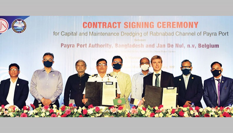 Planning minister MA Mannan is seen along with others at the signing ceremony of a fresh deal with Belgian company Jan de Nul to dredge Rabnabad channel in the Bay of Bengal at a city hotel on Sunday. — New Age photo