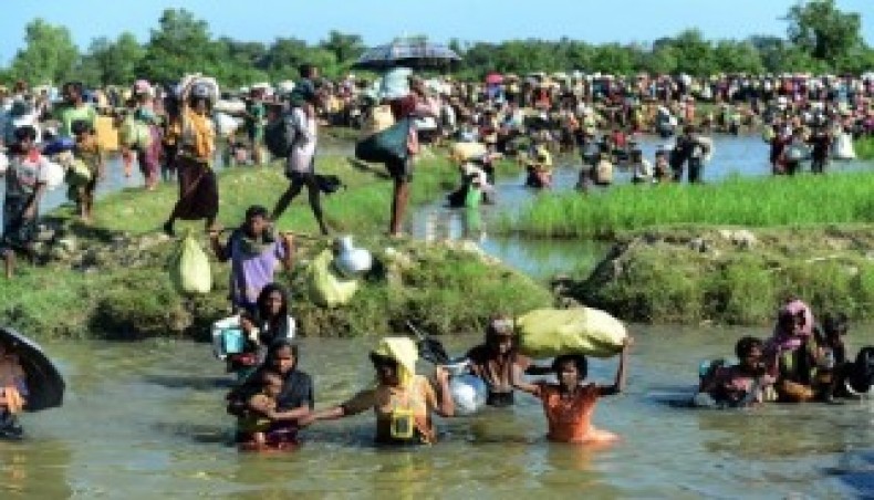 In this file photo taken on October 16, 2017, Rohingya refugees walk through a shallow canal after crossing the Naf River in Palongkhali near Ukhia, as they flee violence in Myanmar to reach Bangladesh.- AFP photo