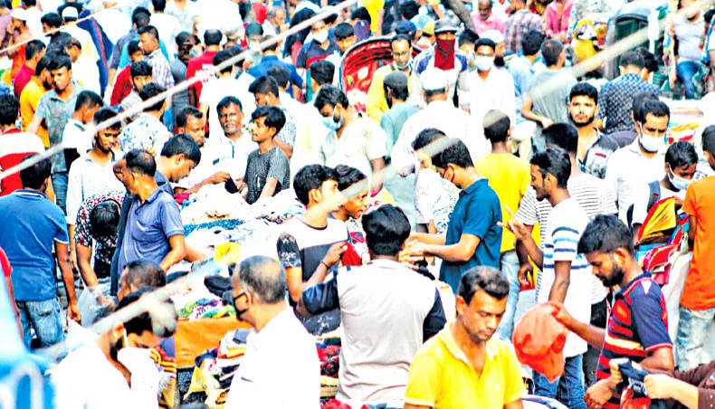 A file photo shows people moving without wearing masks and maintaining physical distancing on Gulistan Road in Dhaka towards the end of 2020. — New Age