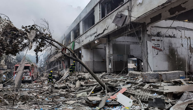 Workers search for victims in a building damaged by a gas line explosion which left at least 12 people dead and nearly 140 others injured in Shiyan, in central China’s Hubei province on June 13, 2021. — AFP photo