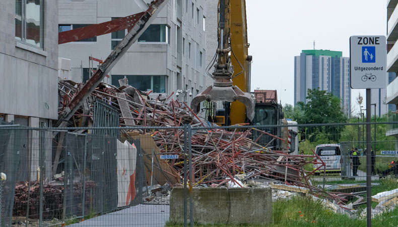 Rescue workers inspect the rubble of a collapsed building, a day after a school construction site partially collapsed in the Belgian city of Antwerp on June 19, 2021. — AFP photo