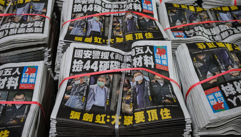 Freshly printed copies of the local Apple Daily newspaper are seen stacked in Hong Kong early on June 18, 2021, after Hong Kong police arrested the chief editor and four executives of the pro-democracy newspaper the day before, raiding its newsroom for a second time in the latest blow to the outspoken tabloid. — AFP photo