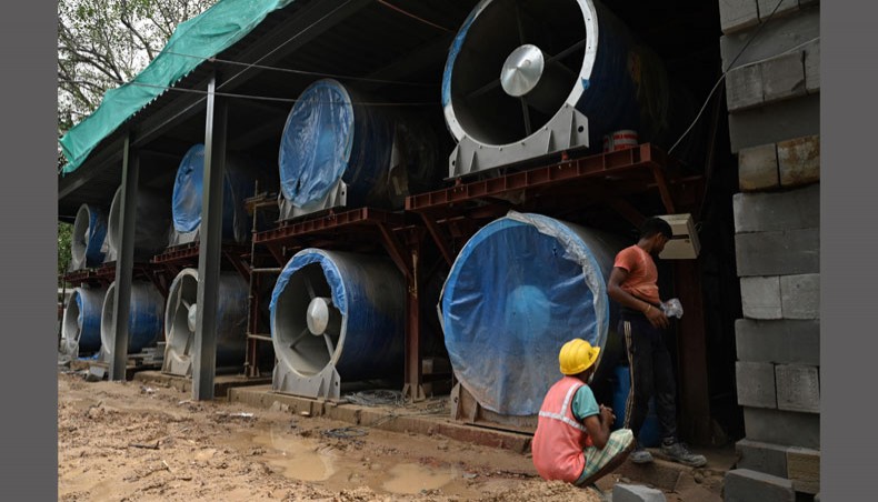 This photo taken on July 21, 2021, shows workers at the construction site of a 25-metre high smog tower near Connaught Place in New Delhi. — AFP