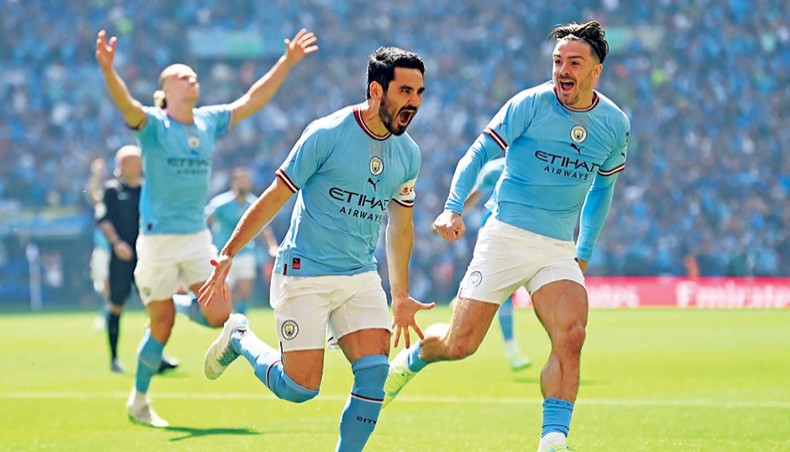 Manchester City's Erling Haaland holds the winners trophy as he celebrates  winning the English FA Cup final soccer match between Manchester City and  Manchester United at Wembley Stadium in London, Saturday, June